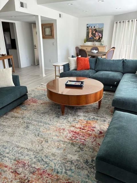 Walk in the front door to the open floor plan. Enjoy the open living area. This bright home has hardwood floors and an inviting blue and white decor.  Dining area with sliding doors that lead to the deck with table and chairs.
