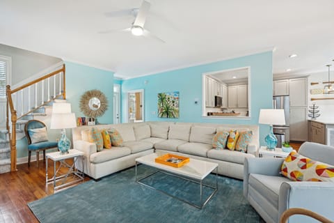 Sink into this stylish sectional where turquoise walls and coastal accents create your perfect seaside retreat atmosphere.