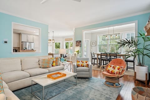 Unwind in your stylish living room with plush seating, vibrant accents, and an open-concept flow to your fully-equipped kitchen and bright dining area.