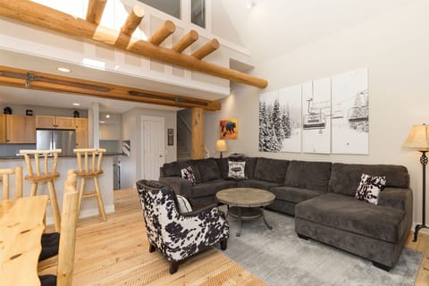 Open floor great room w/ rustic hardwood floors, vaulted ceiling, gas fireplace