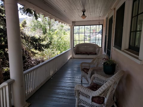 Cozy shaded covered porch with views of Red Mtn & Iron Mtn.