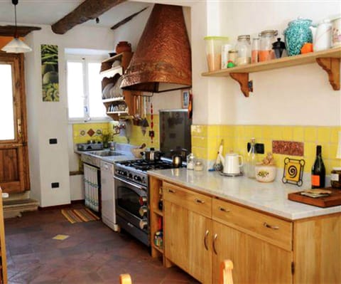 Well equipped kitchen with  patio doors to second terrace 