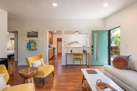 The main living area includes a WFH desk setup.