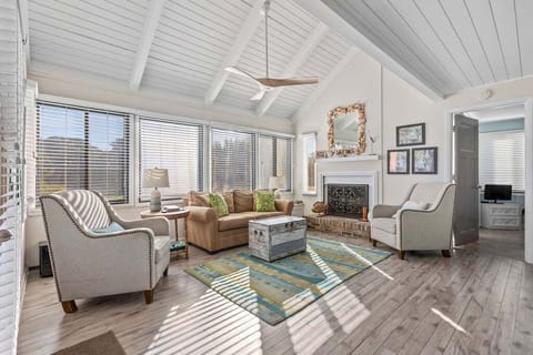 This cottage has new gray toned wood floors, high ceilings & comfy furnishings.