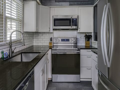 New counter tops, painted cabinets and appliances in the kitchen.