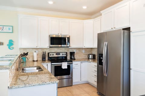 Well Stocked Kitchen with Stainless steel appliances.
