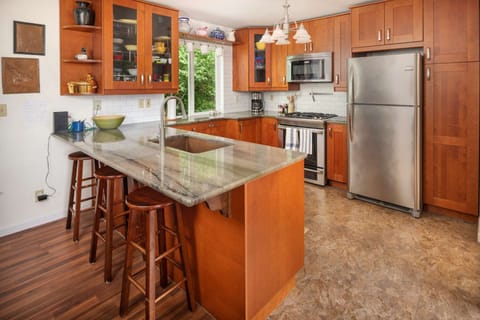 Second floor offers a kitchen and open layout connected to dining and living area