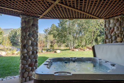 Private outdoor hot tub accessed off lower level lounge