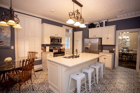 Spacious kitchen furnished with a stove, refrigerator, coffee bar and cookware