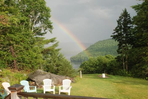 Side yard with view of rainbow, Lake Christopher, horse shoe and fire pit.
