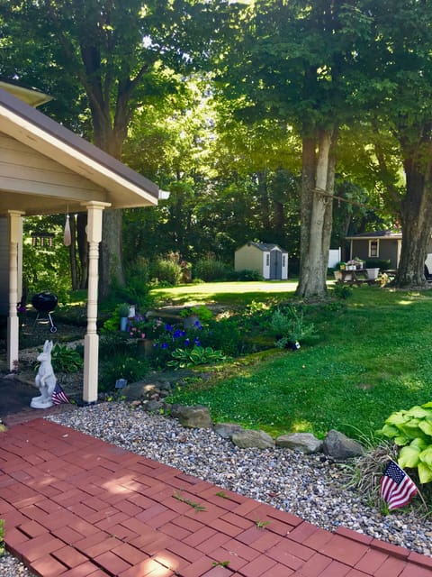 Shady and beautiful yard and garden is perfect for grilling.