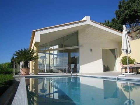 side view of the house with the pool