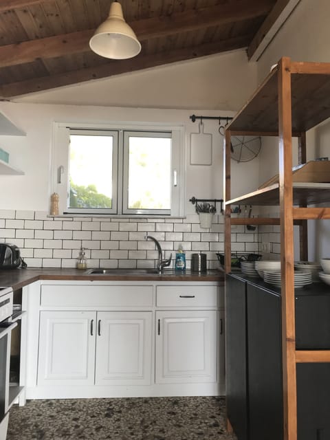 Studio kitchen with its own lockable door and windows towards the garden