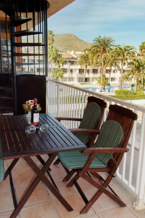 Terrace outside living room overlooking hotel pool complex