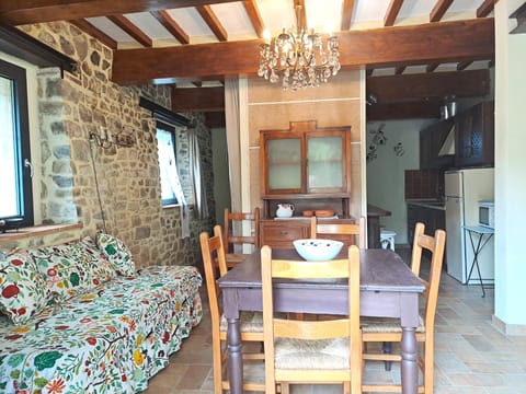 The table , bed /sofa, and the counter in the  dinner room