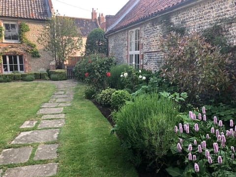 Exterior of barn, with windows looking out onto the pretty garden of Manor House