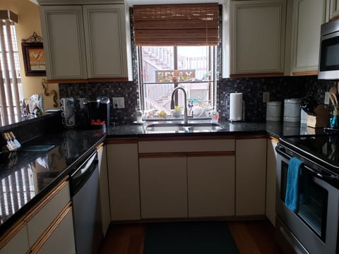 The kitchen is equipped with all stainless steel appliances.