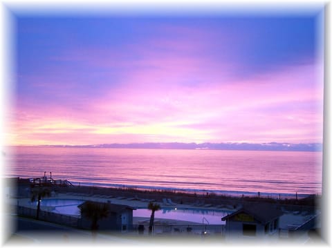 Sunrise on the balcony of our condo--311 B. Overlook ocean and pool. Great View!