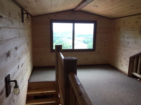 Second floor sleeping loft with view of river