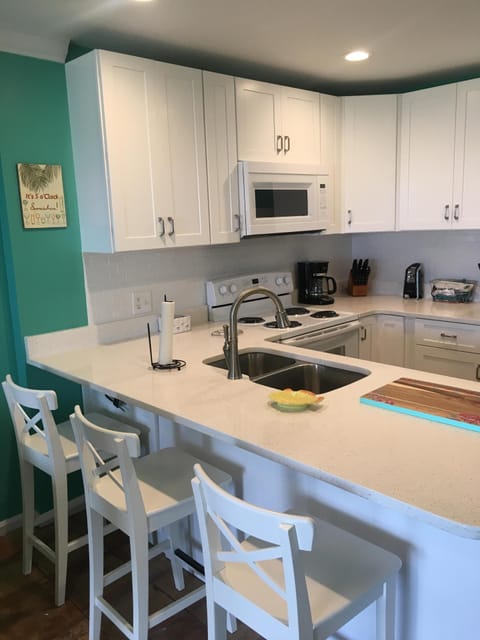 Kitchen has a bar for 3. Kids love the bar.