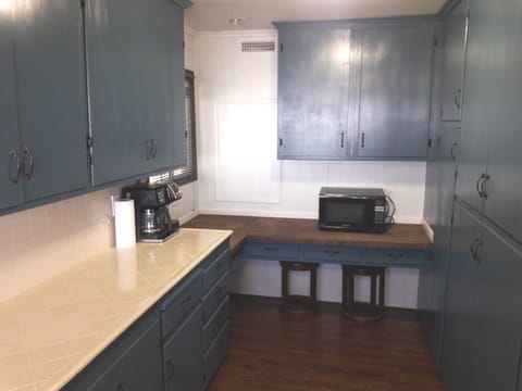 Back of Kitchen with long countertop for buffet. Coffee has pot or keurig choice