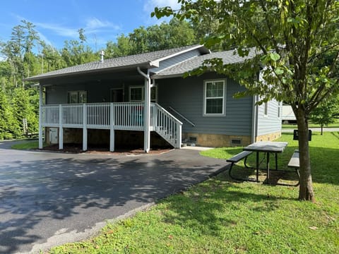 Front of house with grill and picnic table