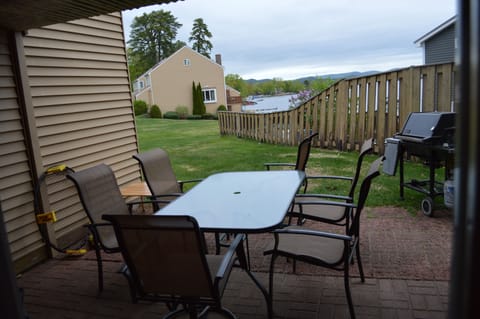 Back patio with outdoor seating and grill