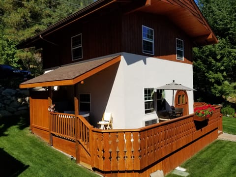 Private deck with private hot tub jacuzzi and bistro table with umbrella
