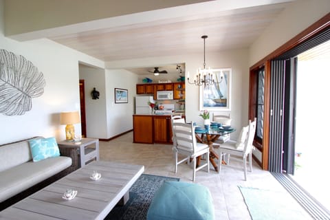 The attractive decor of the living room, dining area and kitchen is bright and c