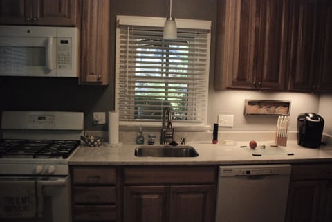 large brand new galley kitchen & appliances sunny & bright during day