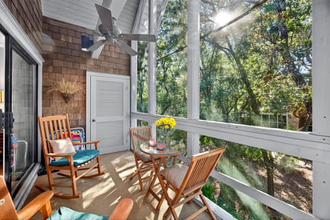 Enjoy coastal breezes from the screened porch at this Seascape Villa on Kiawah Island