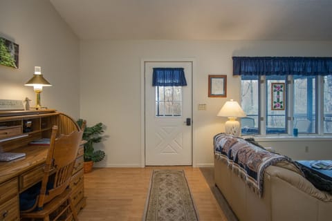 Front entry into living area with desk