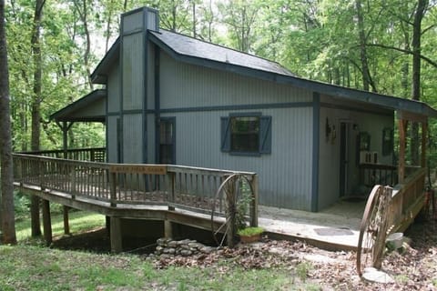 Deerfield cabin nestled at the end of the drive surrounded by solemn woods.