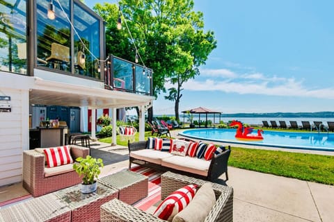 Outdoor seating with pool and lake views for sunny days.