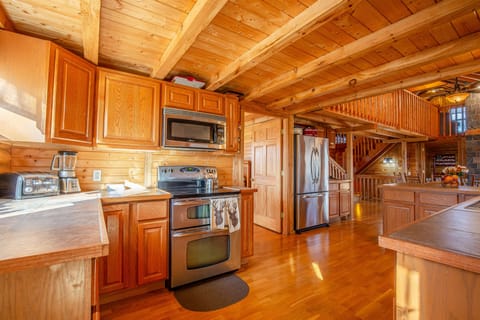 Large well equipped kitchen with dishes, pots and pans and silverware. 