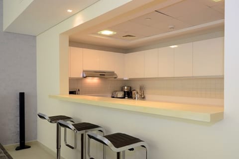 "Enjoy your breakfast at the kitchen bar, top of the line Siemans appliances" 