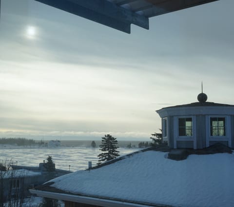 View from the living room to the outer harbor and Coast Guard Station in winter.