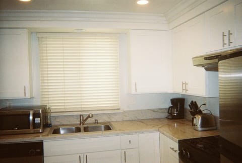New kitchen counters, cabinets, sink, recessed lighting and crown moulding