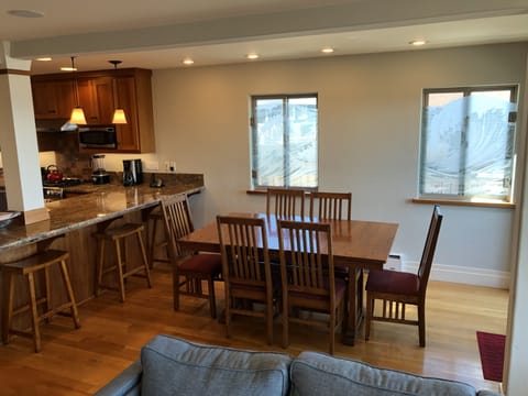 Bar seating for three adjacent to dining room.