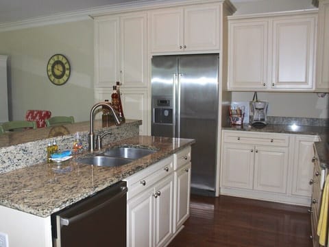 The kitchen has a French door refrigerator and a spacious island.