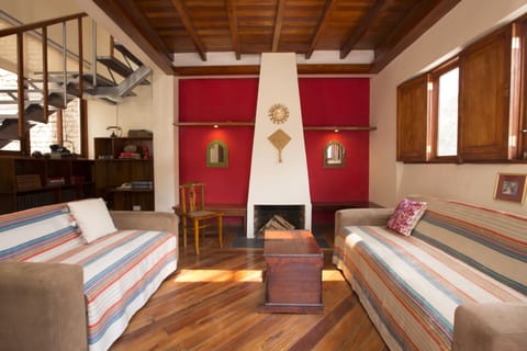 Living room with wooden beans, great view to the mountains and a cozy fireplace