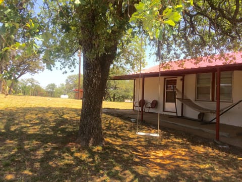 The front porch of the main house with hammock and swing.