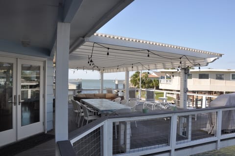 Large outdoor eating area, with chairs and grill