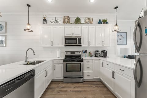 Fully equipped kitchen with stainless steel appliances.