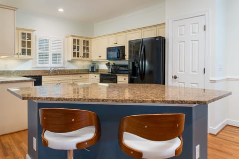 The kitchen island has two stools