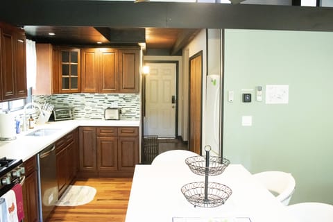 PART OF KITCHEN AND VIEW OF ENTRANCE TO THE HOUSE