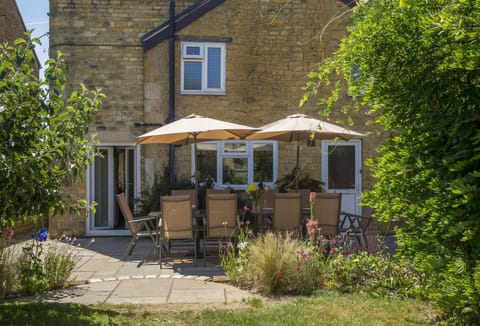 Garden Enclosed garden with table seating twelve guests and barbecue
