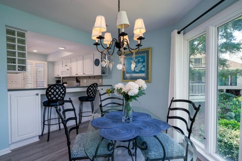 Two counter stools buffer the dining are from the kitchen