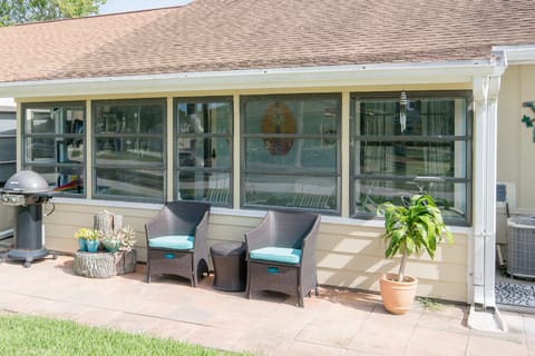 Enclosed back porch and outdoor grill.
