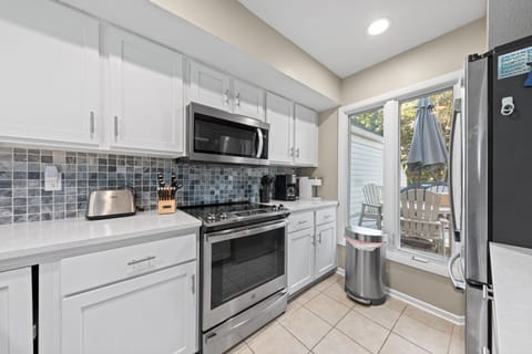 A large window looks out to the front porch. There is both a drip and Keurig coffee maker.